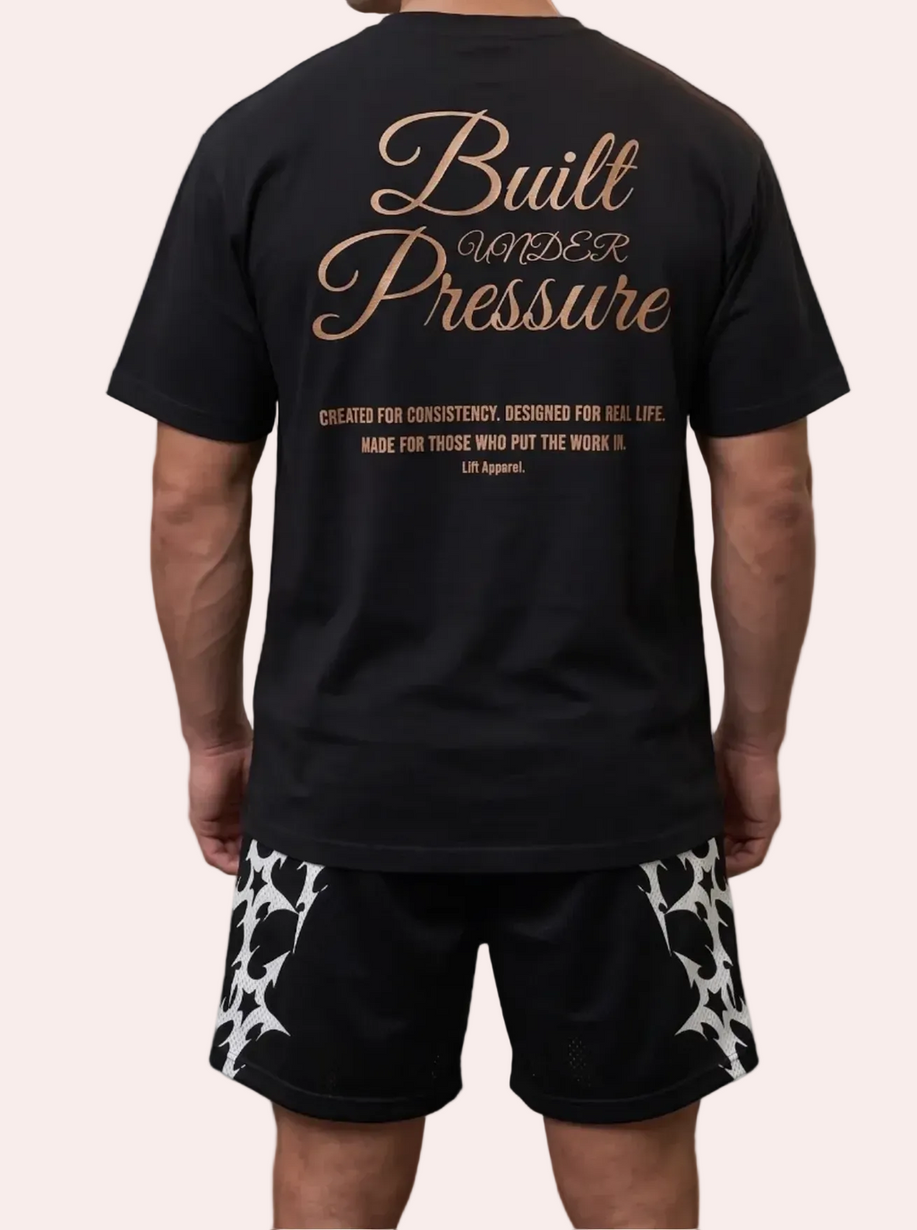 Man wearing a black t-shirt with 'Built Under Pressure' text in a warehouse with stacks of money on fire.