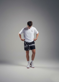 Person wearing a white t-shirt and black shorts with text on a gray background