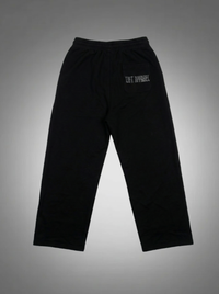 Black sweatpants with a logo on a gray background