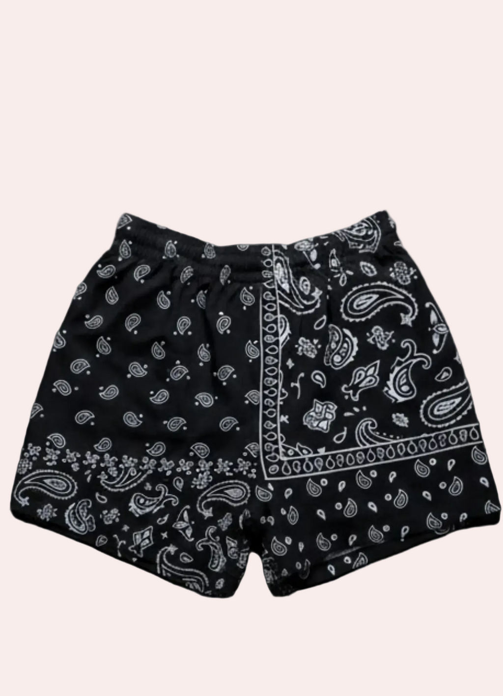 Black shorts with white paisley pattern on a dark background