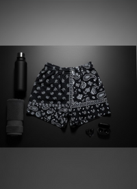 Black shorts with white paisley pattern on a dark background