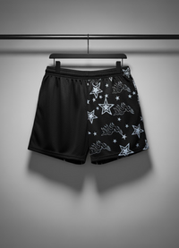 Black shorts with star pattern on a hanger against a gray background