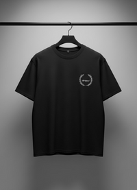 Black t-shirt with a logo on a hanger against a gray background