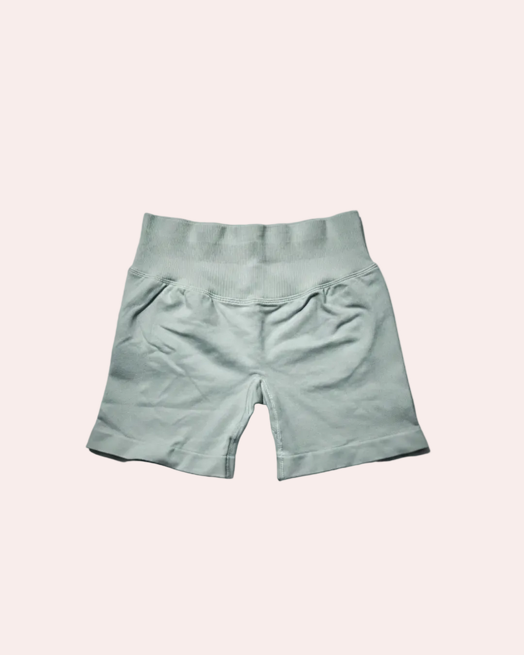 Light gray shorts on a gradient gray background