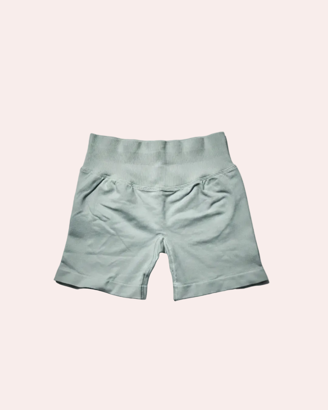 Light gray shorts on a gradient gray background