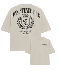 Beige t-shirt with 'Consistency Club' design on a white background
