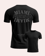 Black t-shirt with 'MIAMI FLORIDA MIAMI' text on the back, displayed from front and back views.