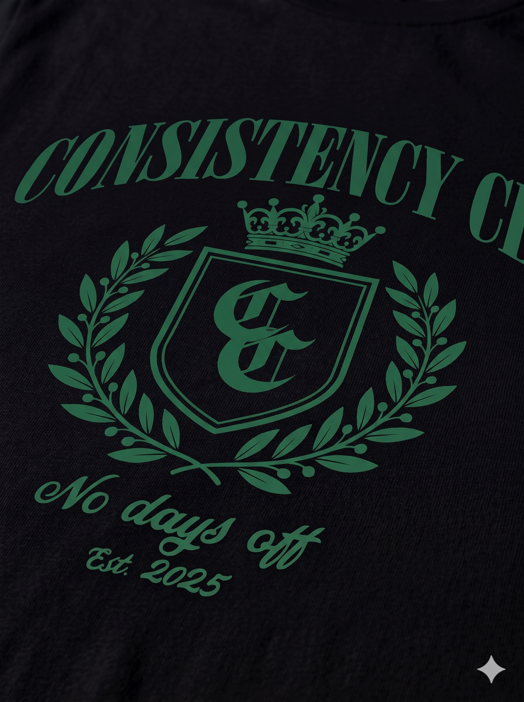 Black shirt with green 'Consistency Club' logo and text on a dark background