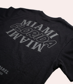 Black t-shirt with 'MIAMI FLORIDA' text on a white background