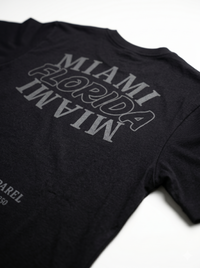 Black t-shirt with 'MIAMI FLORIDA' text on a white background