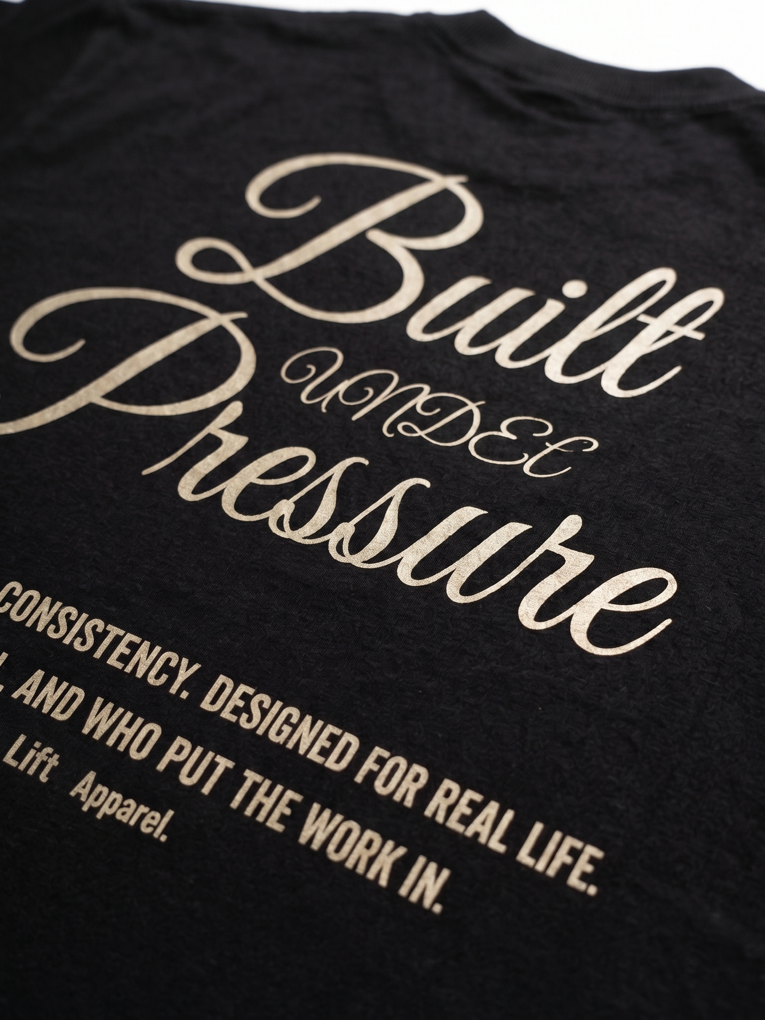 Black t-shirt with gold text on a plain background