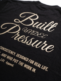 Black t-shirt with gold text on a plain background