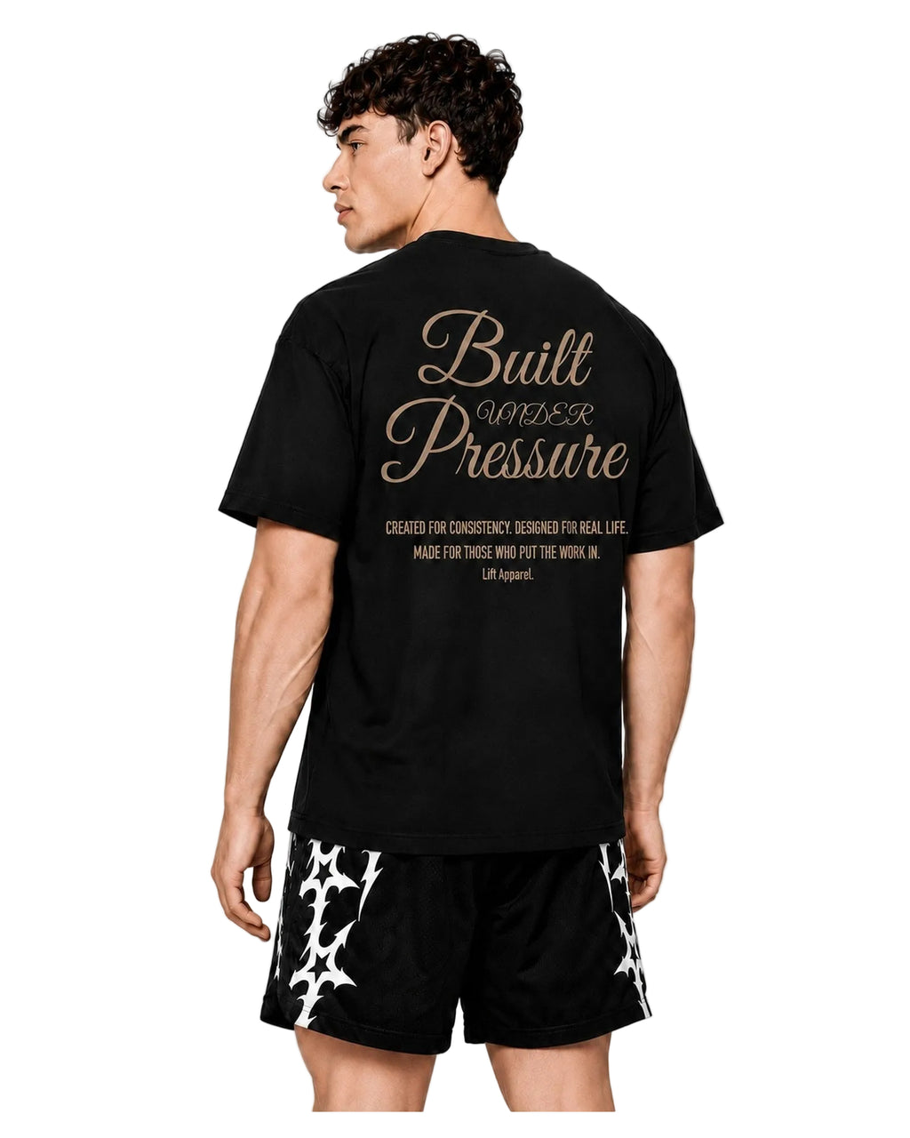 Back view of the black Pressure oversized tee with gold Built Under Pressure script print