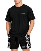 Front view of the black Pressure oversized gym tee worn with patterned training shorts
