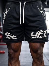 Black shorts with white drawstring and 'LIFT APPAREL' branding on a blurred background