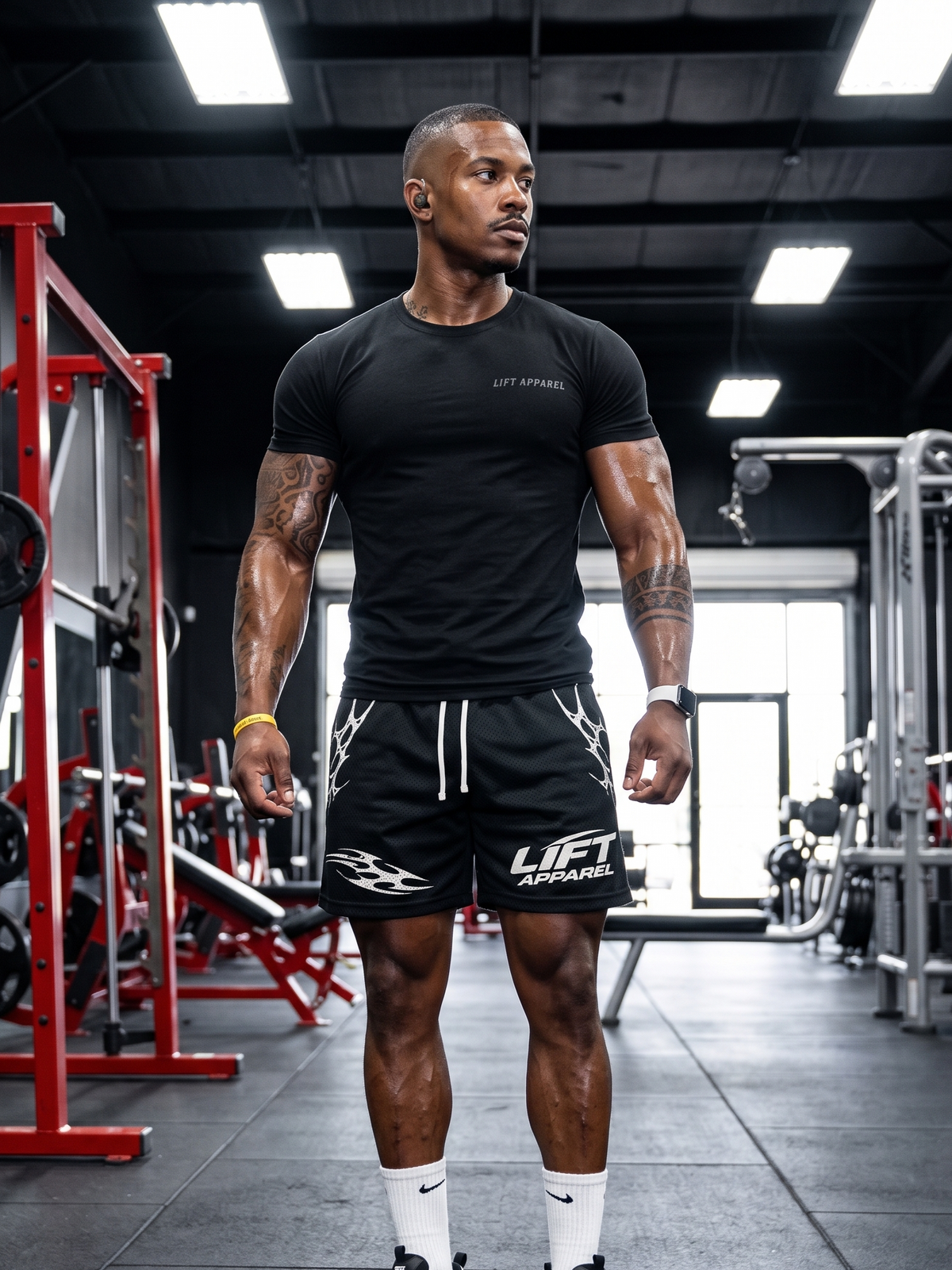 Man in black athletic wear standing in a gym