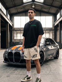 Man standing in front of a car in an industrial setting