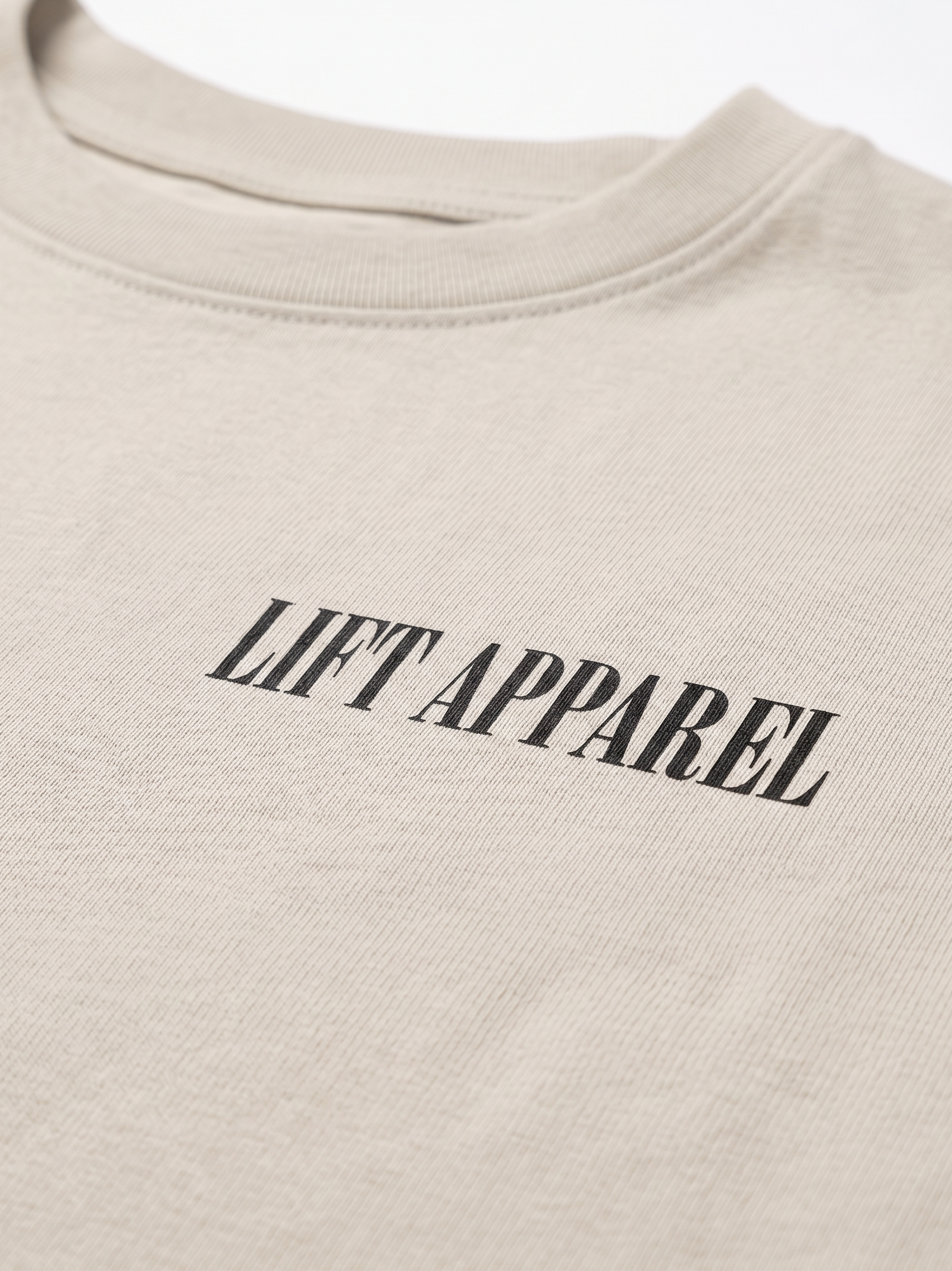 Beige sweatshirt with 'LIFT APPAREL' text on a white background