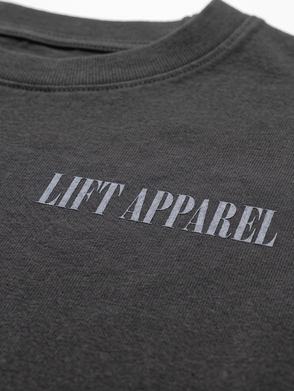 Dark gray t-shirt with 'LIFT APPAREL' text on a white background