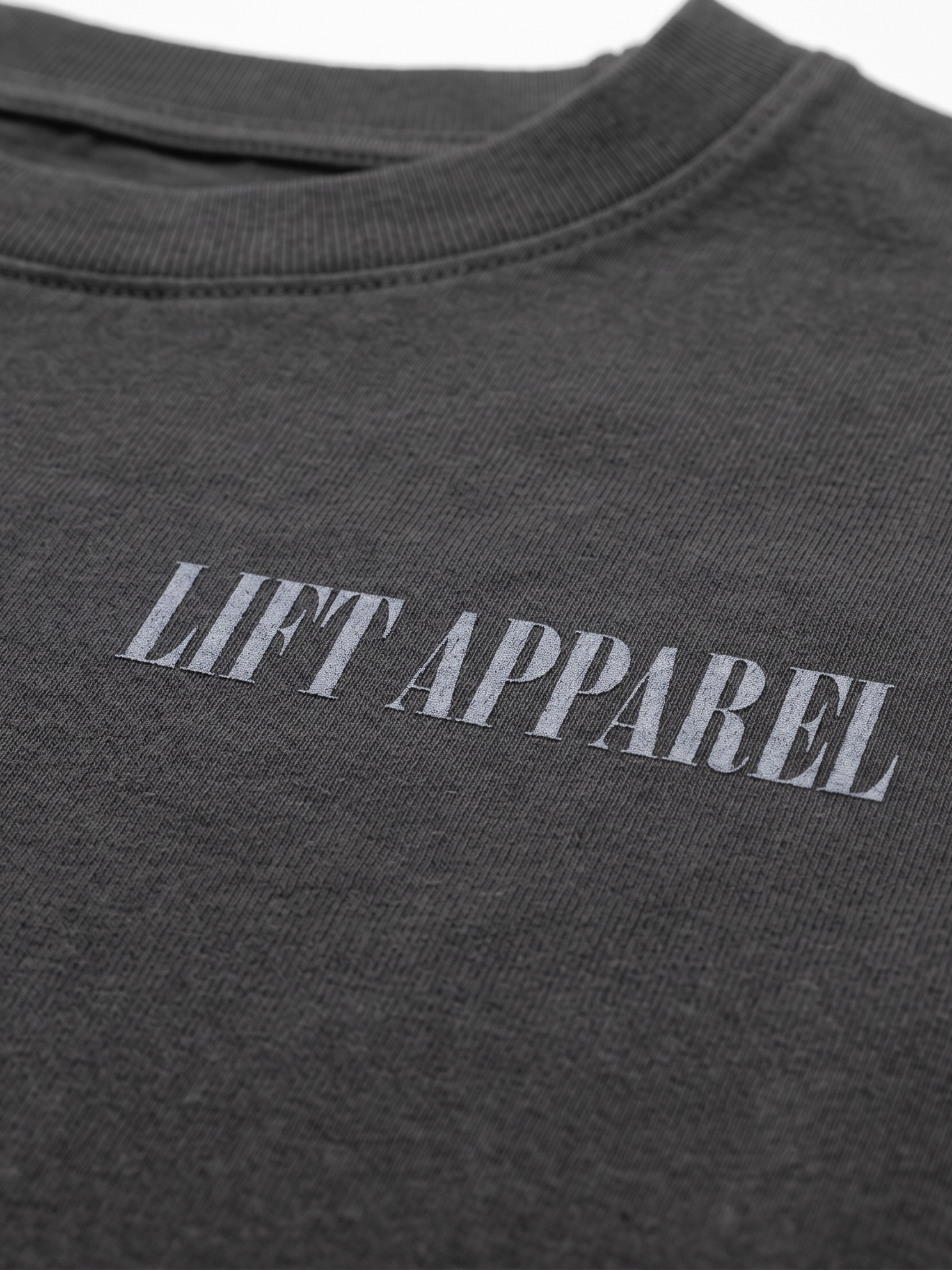 Dark gray t-shirt with 'LIFT APPAREL' text on a white background