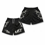 Black Apex gym shorts with white tribal print and Lift Apparel logo, front and back flat lay